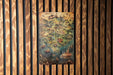 a painting hanging on a wooden wall