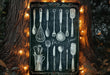 a chalkboard with utensils drawn on it in front of a tree