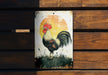 a rooster painted on a sign on a wooden bench