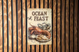 a sign on a wooden wall that says ocean feast