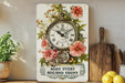 a clock on a shelf with flowers on it