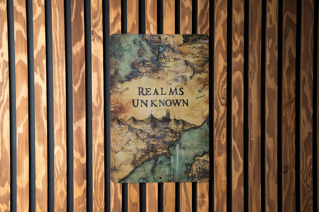 a book on a wooden wall that reads, realms unknown