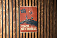 a sign on a wooden wall that says reach new worlds