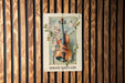 a picture of a violin on a wooden wall