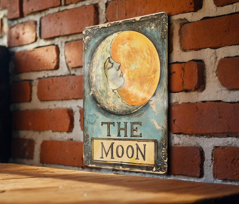 a picture of the moon on a sign on a brick wall
