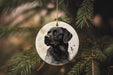 a black dog ornament hanging from a christmas tree