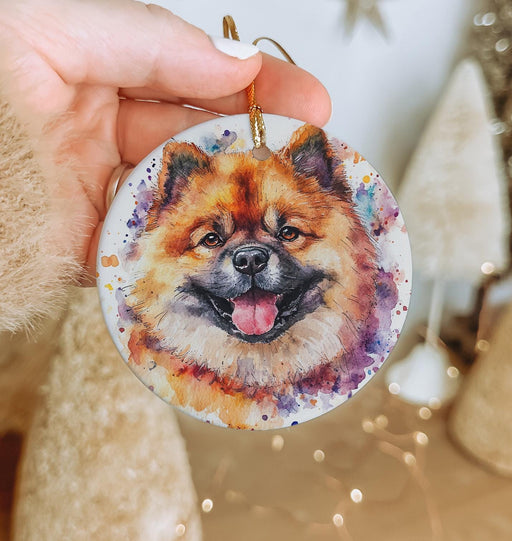 a person holding a dog ornament in their hand