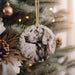 a dog ornament hanging from a christmas tree