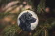 a black dog ornament hanging from a christmas tree