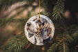 a dog ornament hanging from a christmas tree