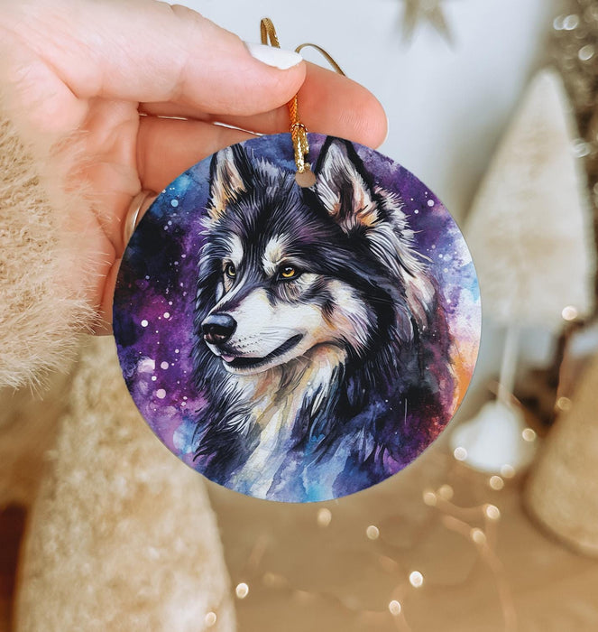 a person holding a small ornament with a wolf on it