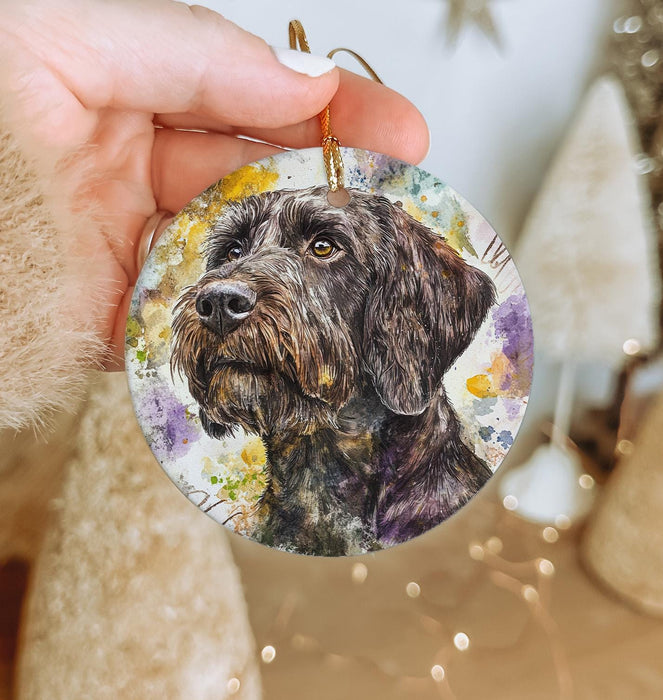 a hand holding a christmas ornament with a picture of a dog
