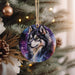 a picture of a wolf ornament hanging on a christmas tree