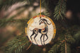 a ceramic ornament hanging from a christmas tree