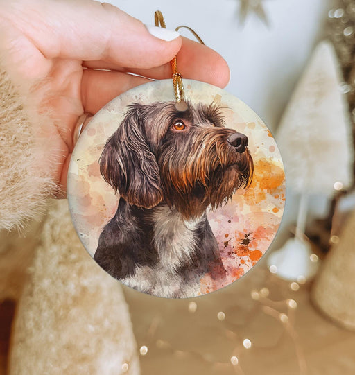 a hand holding a christmas ornament with a picture of a dog