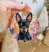 a person holding a small dog ornament in their hand