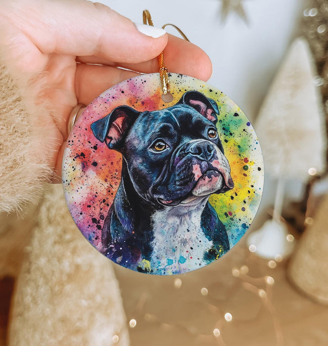 a person holding a dog ornament in their hand