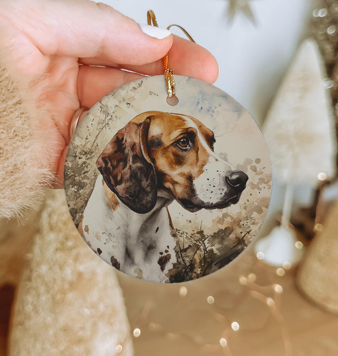 a hand holding a round ornament with a picture of a dog on it