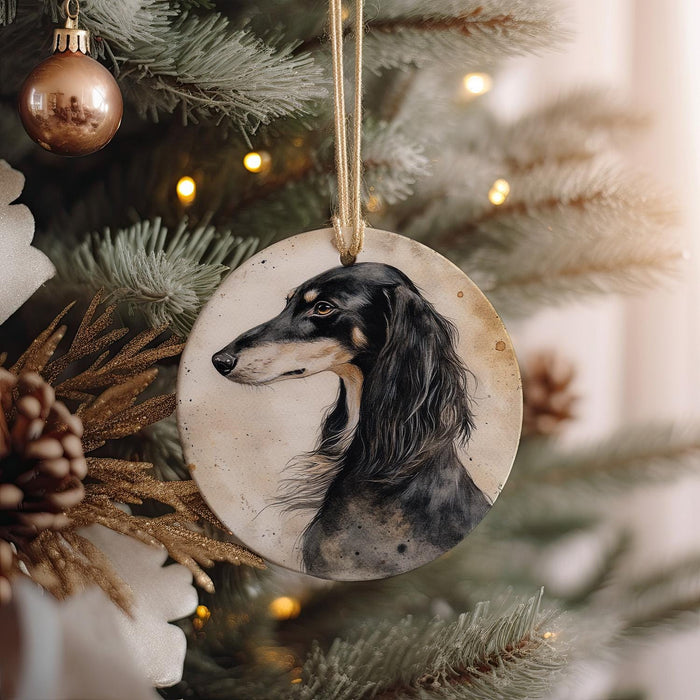 a black and white dog ornament hanging from a christmas tree