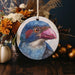 a picture of a blue bird on a round ornament
