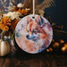 a ceramic ornament with a picture of a fox on it