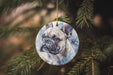 a ceramic ornament hanging from a christmas tree