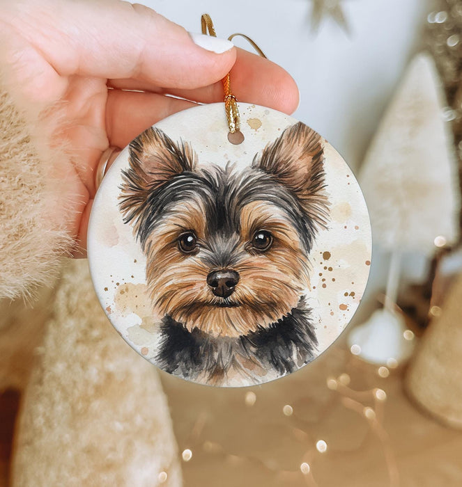 a person holding a dog ornament in their hand