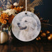 a picture of a white dog on a glass ornament