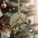 a christmas ornament hanging from a christmas tree