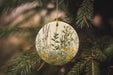 a ceramic ornament hanging from a pine tree