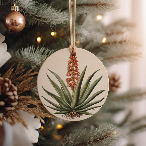 a ceramic ornament hanging from a christmas tree