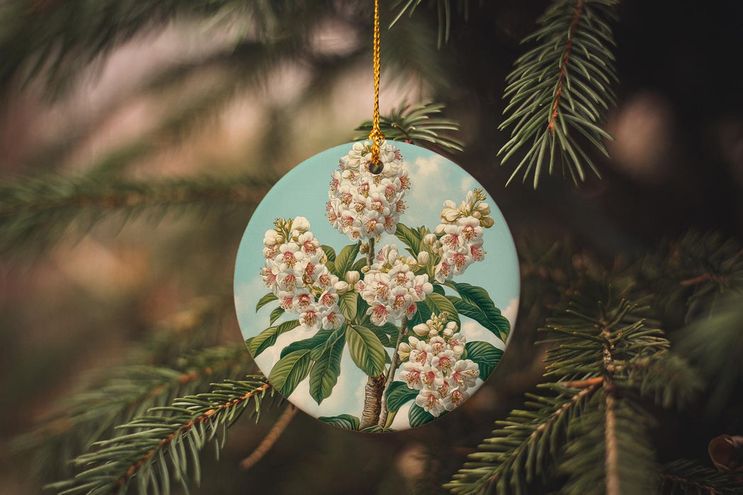 a ceramic ornament hanging from a pine tree