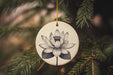 a ceramic ornament hanging from a christmas tree