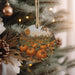 a christmas ornament hanging from a christmas tree