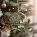 a christmas ornament hanging from a christmas tree