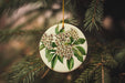 a white ornament with a bunch of flowers on it