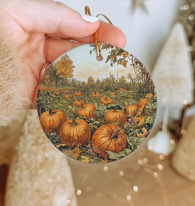 a person holding a plate with a painting of pumpkins on it