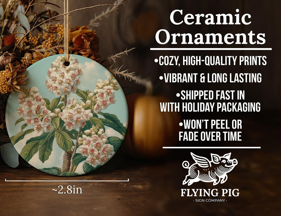 a ceramic ornament with a picture of a flowering tree