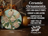 a ceramic ornament with a picture of a flowering tree