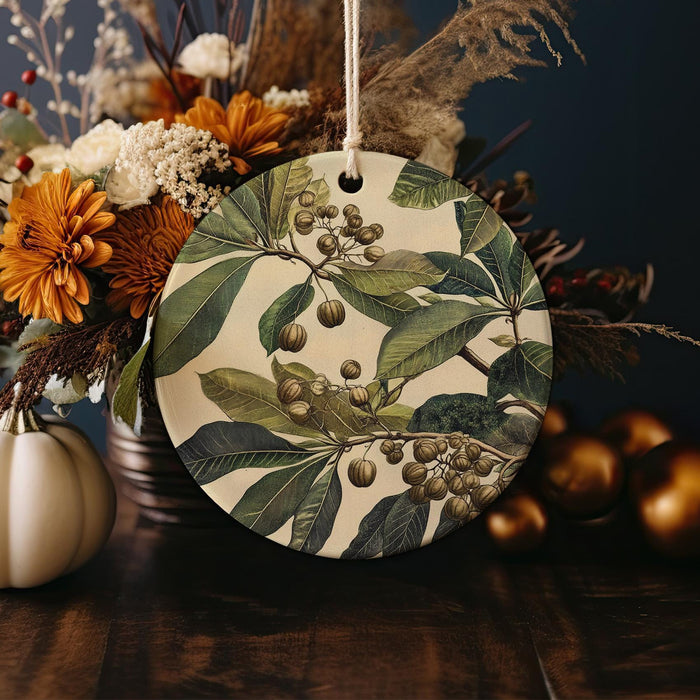 a ceramic ornament with leaves and berries on it