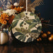 a ceramic ornament with leaves and berries on it