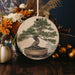 a ceramic ornament with a bonsai tree on it