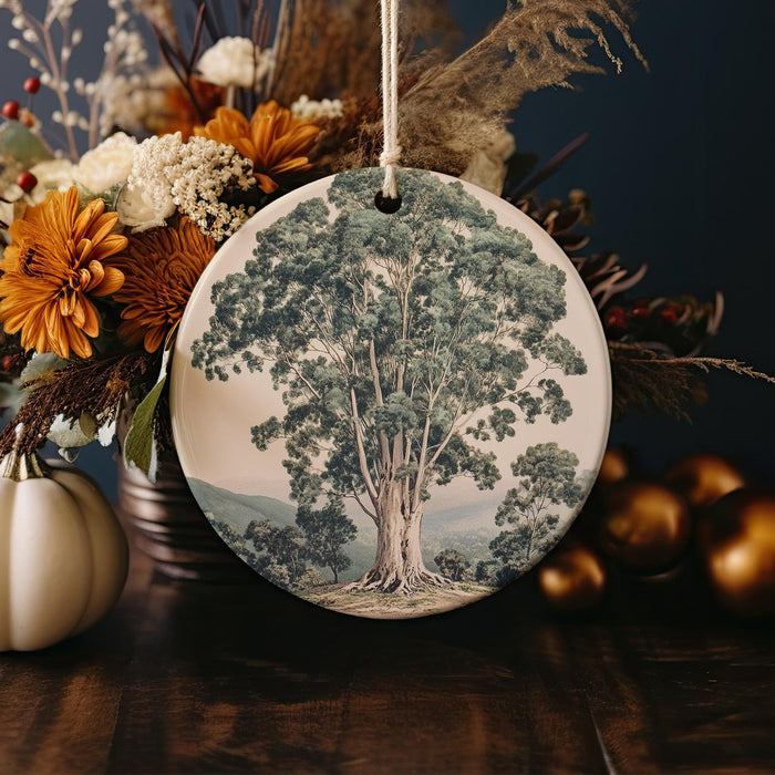 a ceramic ornament with a picture of a tree on it