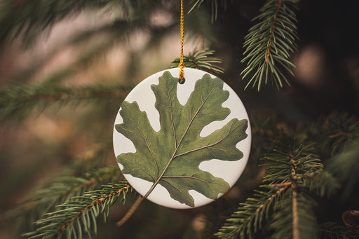 a ceramic ornament hanging from a christmas tree