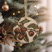 a wooden ornament hanging from a christmas tree
