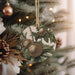 a christmas ornament hanging from a christmas tree