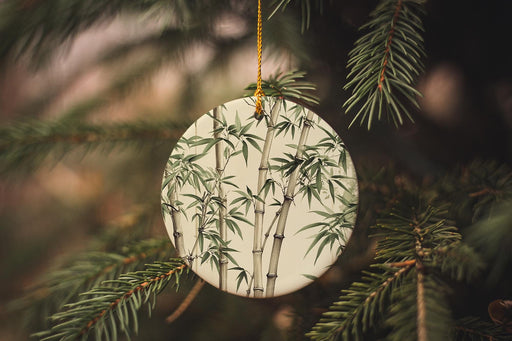 a ceramic ornament hanging from a pine tree