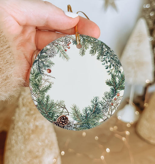 a person holding a christmas ornament in their hand