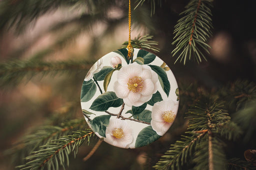 a ceramic ornament hanging from a pine tree