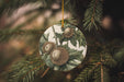 a ceramic ornament hanging from a christmas tree
